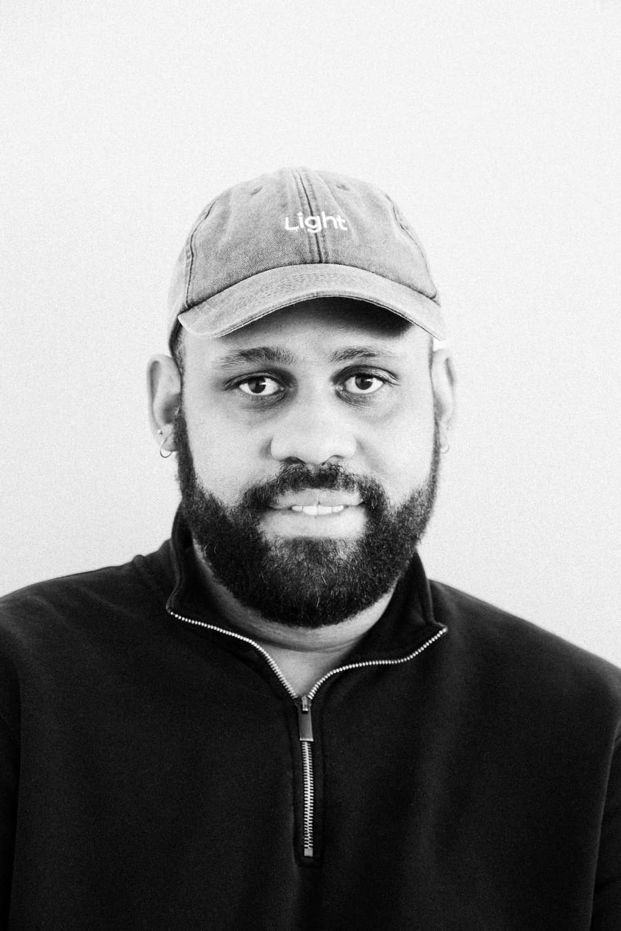 Studio headshot of a Light teammate wearing a Light cap