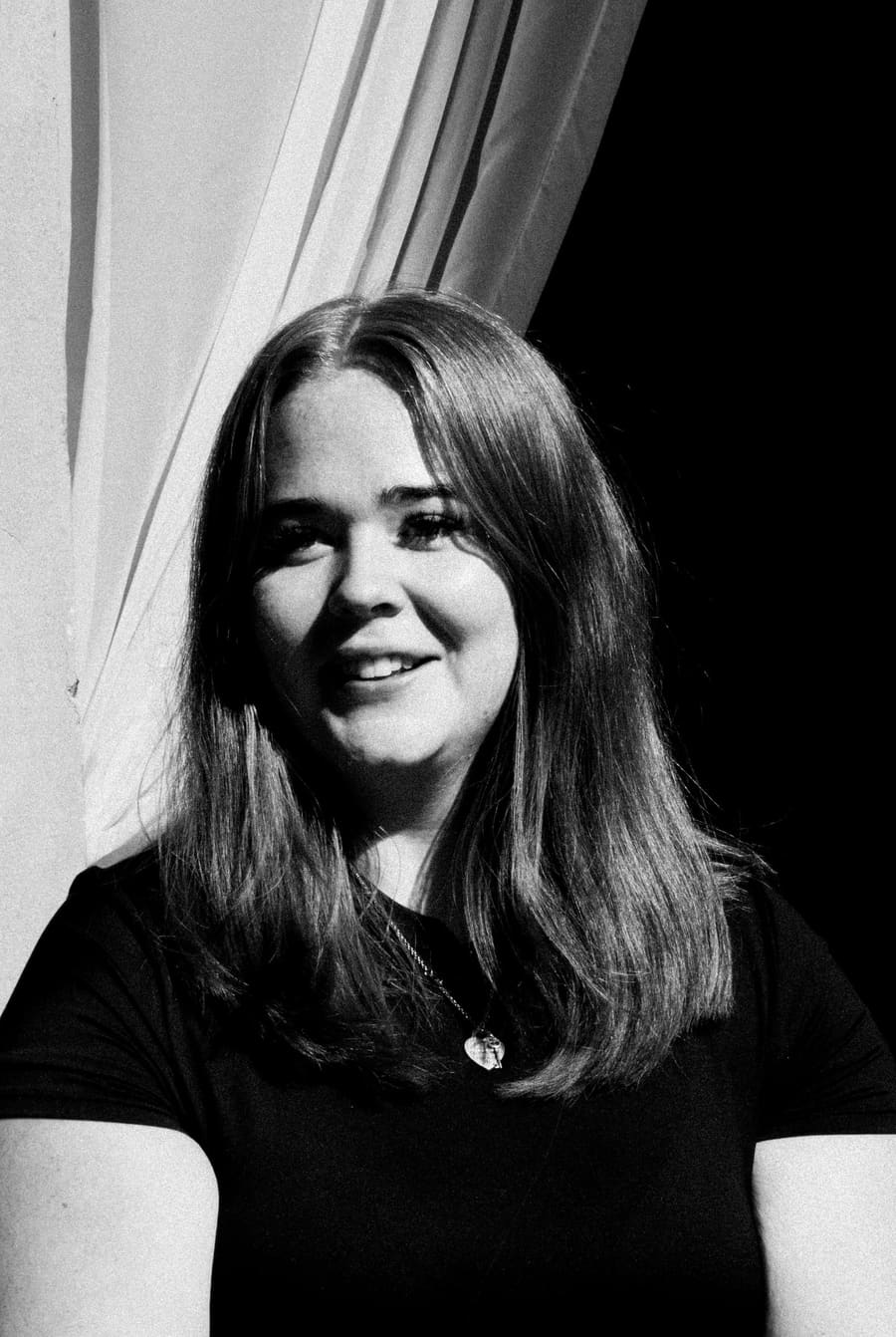 Studio headshot of a Light teammate in front of a curtain