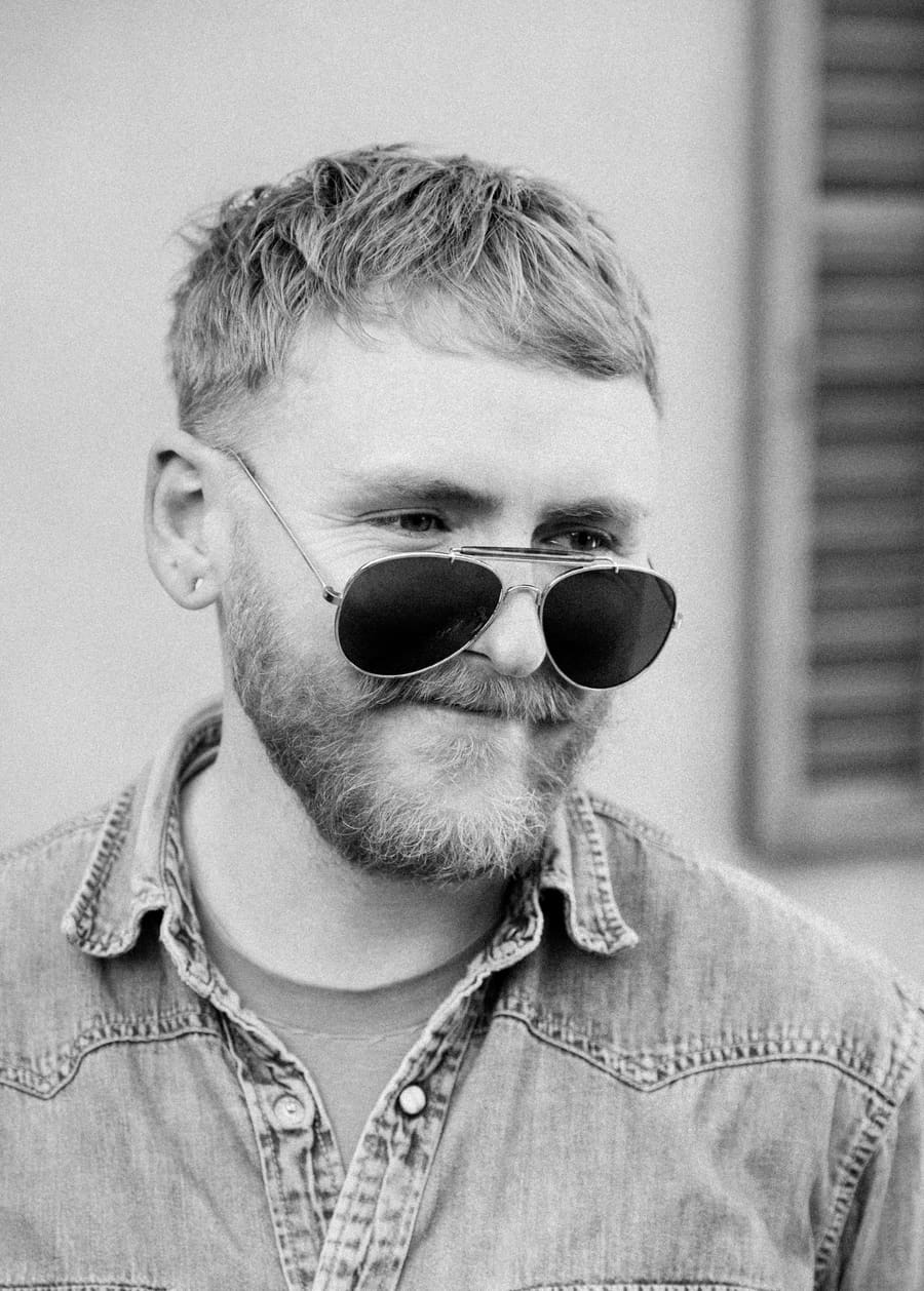 Studio headshot of a Light teammate wearing sunglasses