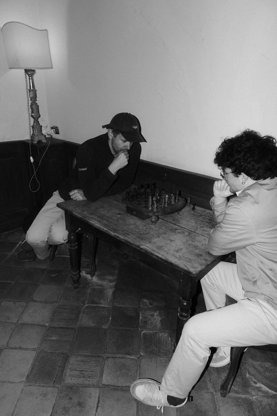 Two teammates deep in concentration playing chess